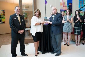 President Hedy Popson shakes hands with Plano Chamber of Commerce