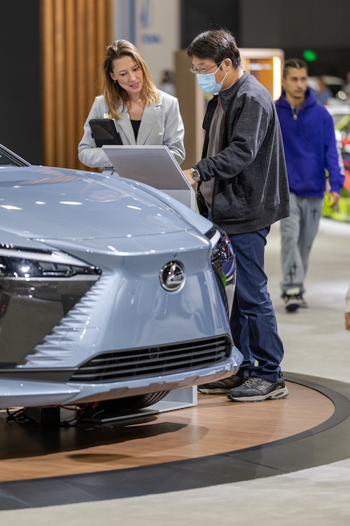 Woman at Lexus trade show interacting with visitors 